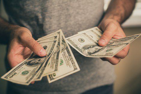 Hands Holding Cash — Pennsauken, NJ — River Road Recycling