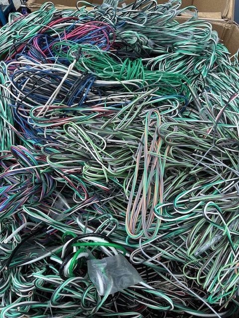 A pile of electric wires sitting on top of each other.