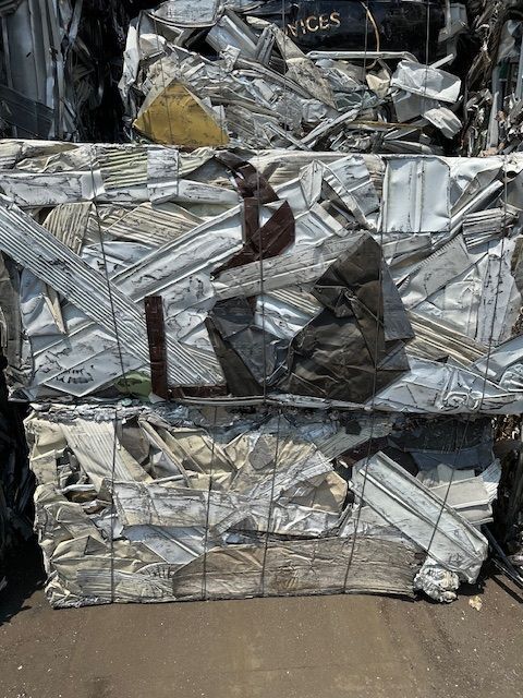 A pile of scrap metal is stacked on top of each other.