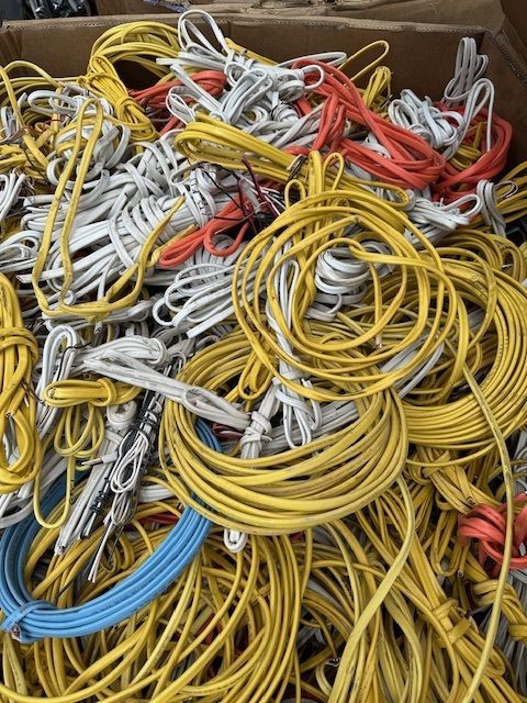 A pile of yellow , white , and red wires in a box.
