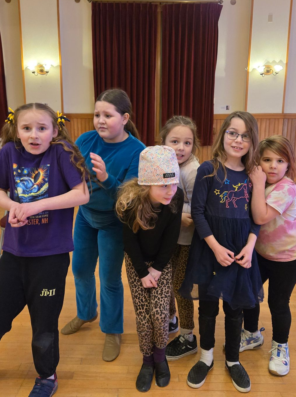 A group of young girls with scripts having fun