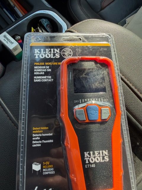 Klein Tools orange digital inspection camera in retail packaging inside a car cup holder