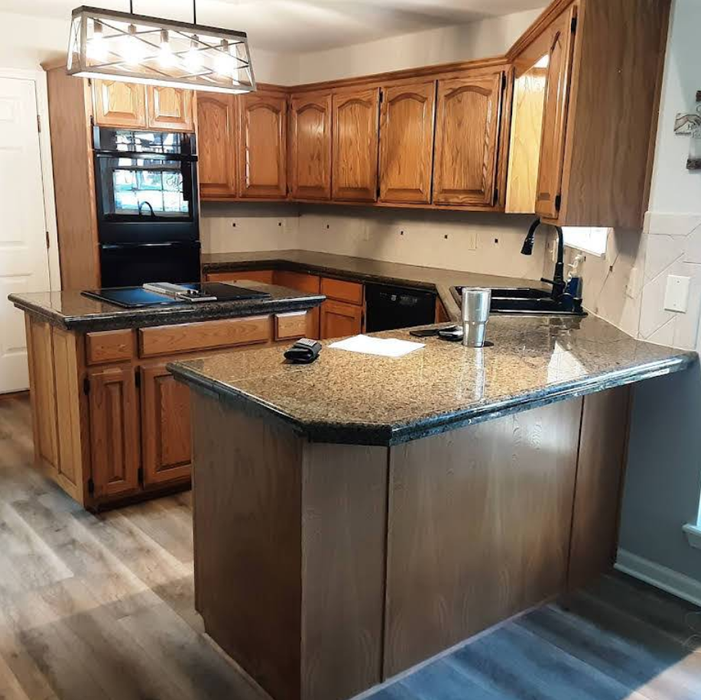 Kitchen with wooden cabinets, granite countertops, and built-in appliances.