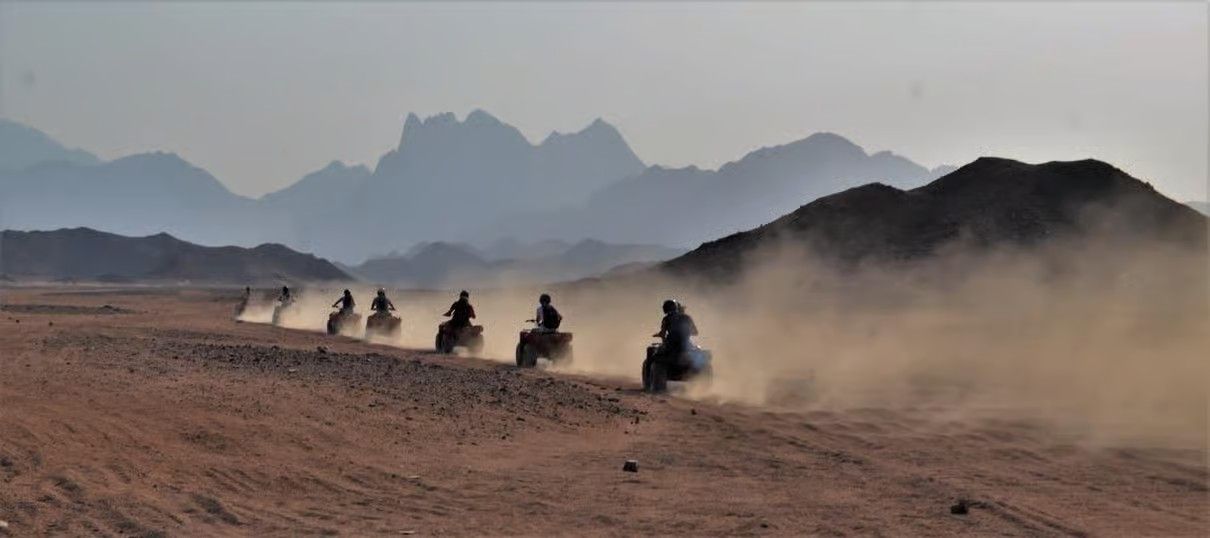 Hurghada desert at sunset with Bedouin camp, mountains and clear Egyptian night sky