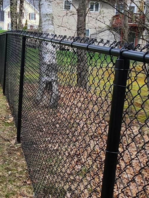 There is a barbed wire fence in the middle of a field.