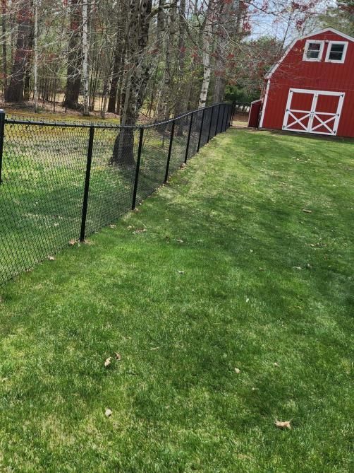 A barbed wire fence is attached to a wooden post
