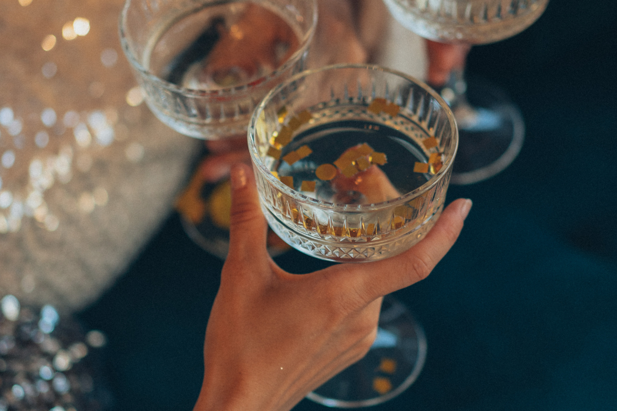 A woman is holding a glass of champagne in her hand.