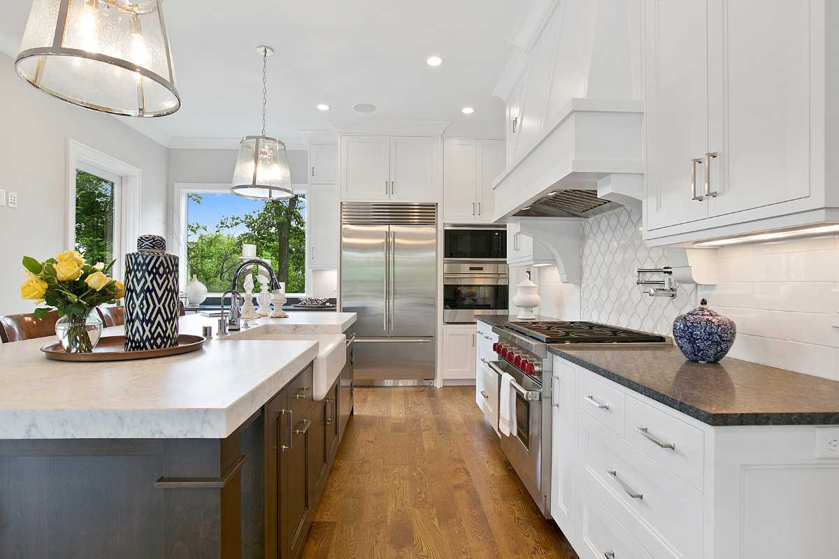 A kitchen with white cabinets and stainless steel appliances