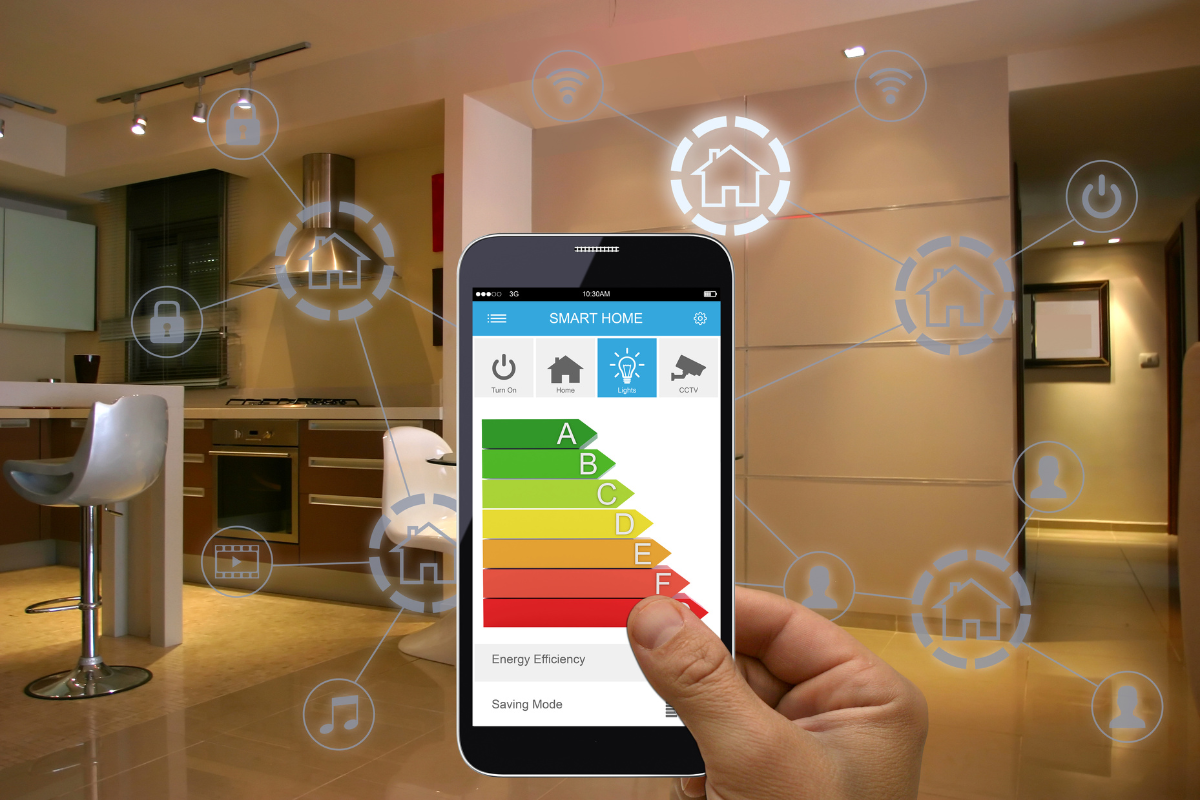 A hand is holding a smart phone with an energy efficiency chart on the screen
