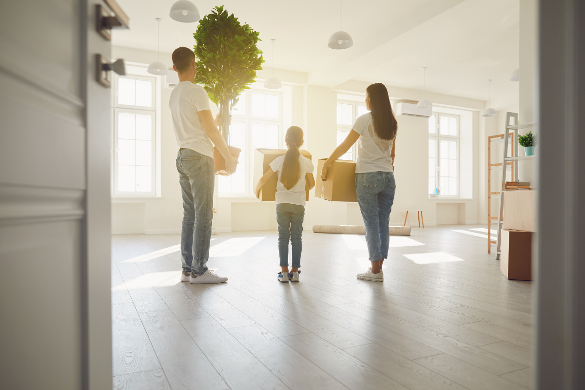 A family is moving into a new home and holding boxes