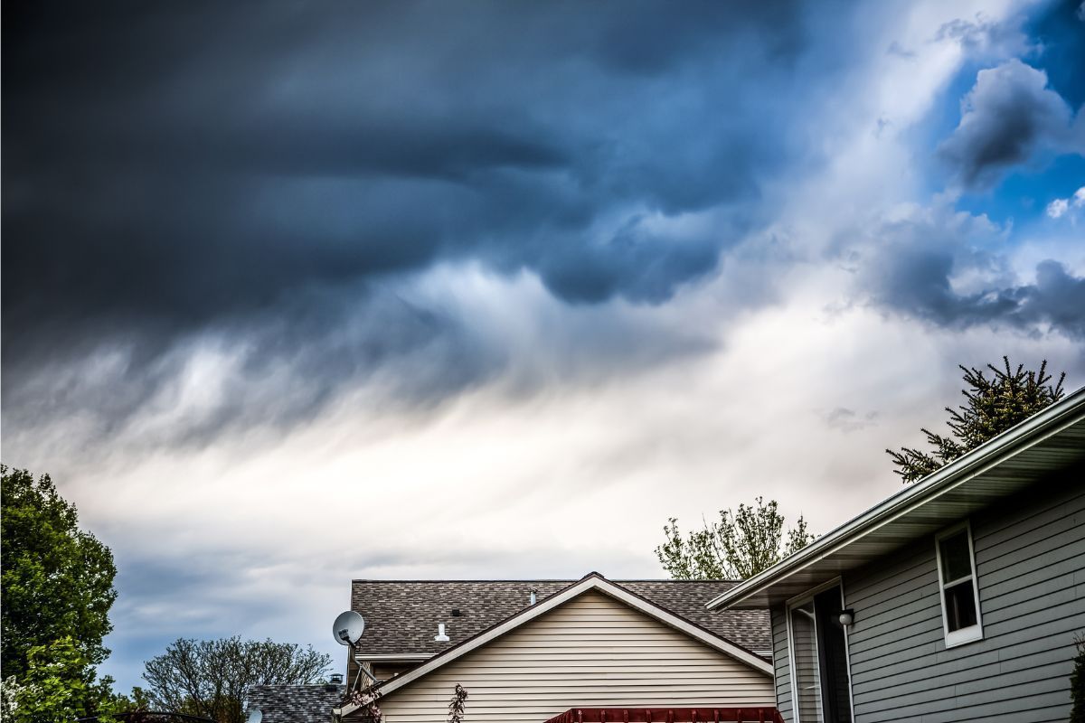 A house with a stormy sky in the background