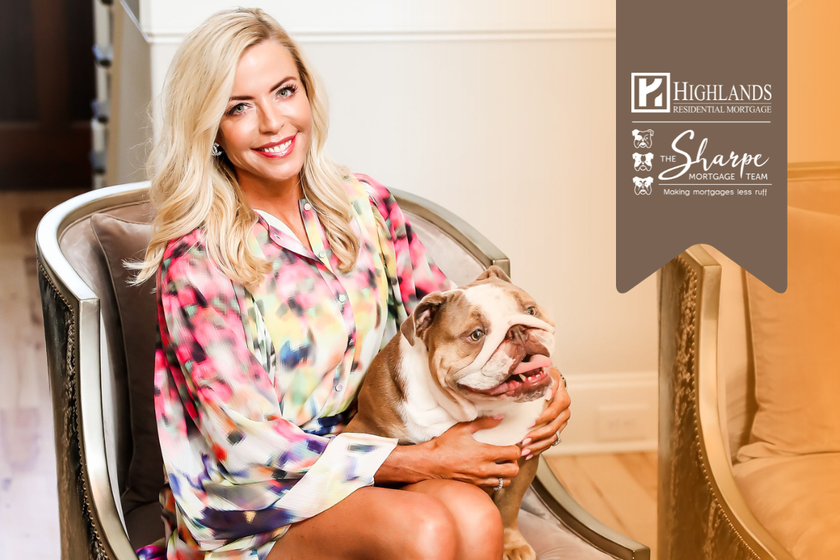 A woman is sitting in a chair holding a dog