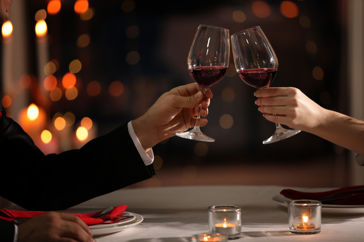 A man and a woman are toasting with wine glasses