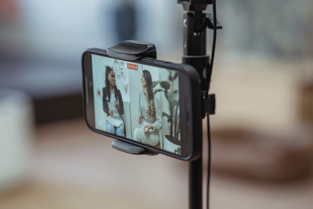 A cell phone is being used to record a video of two women