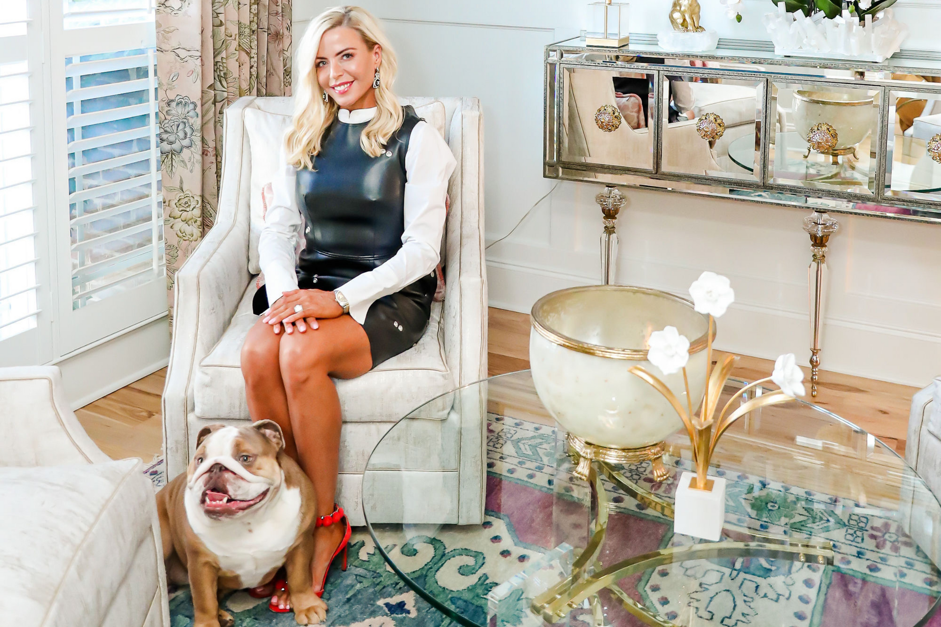 A woman is sitting in a chair next to a dog