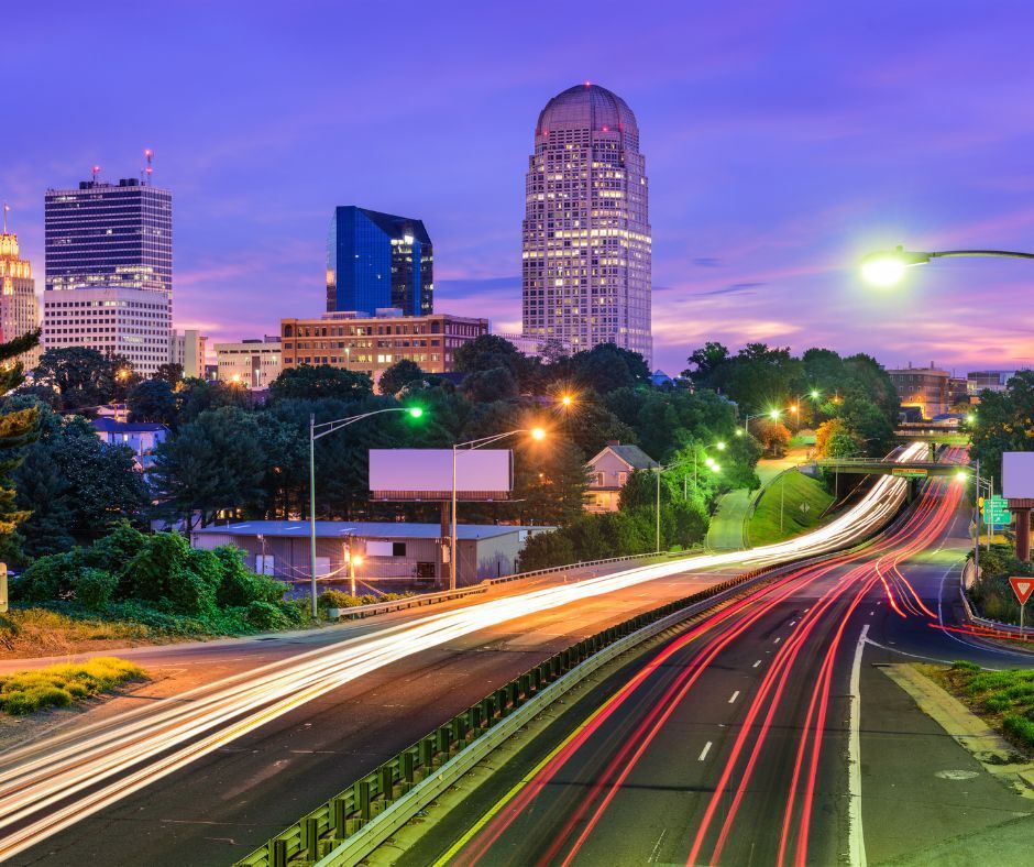 A highway at night with a city in the background
