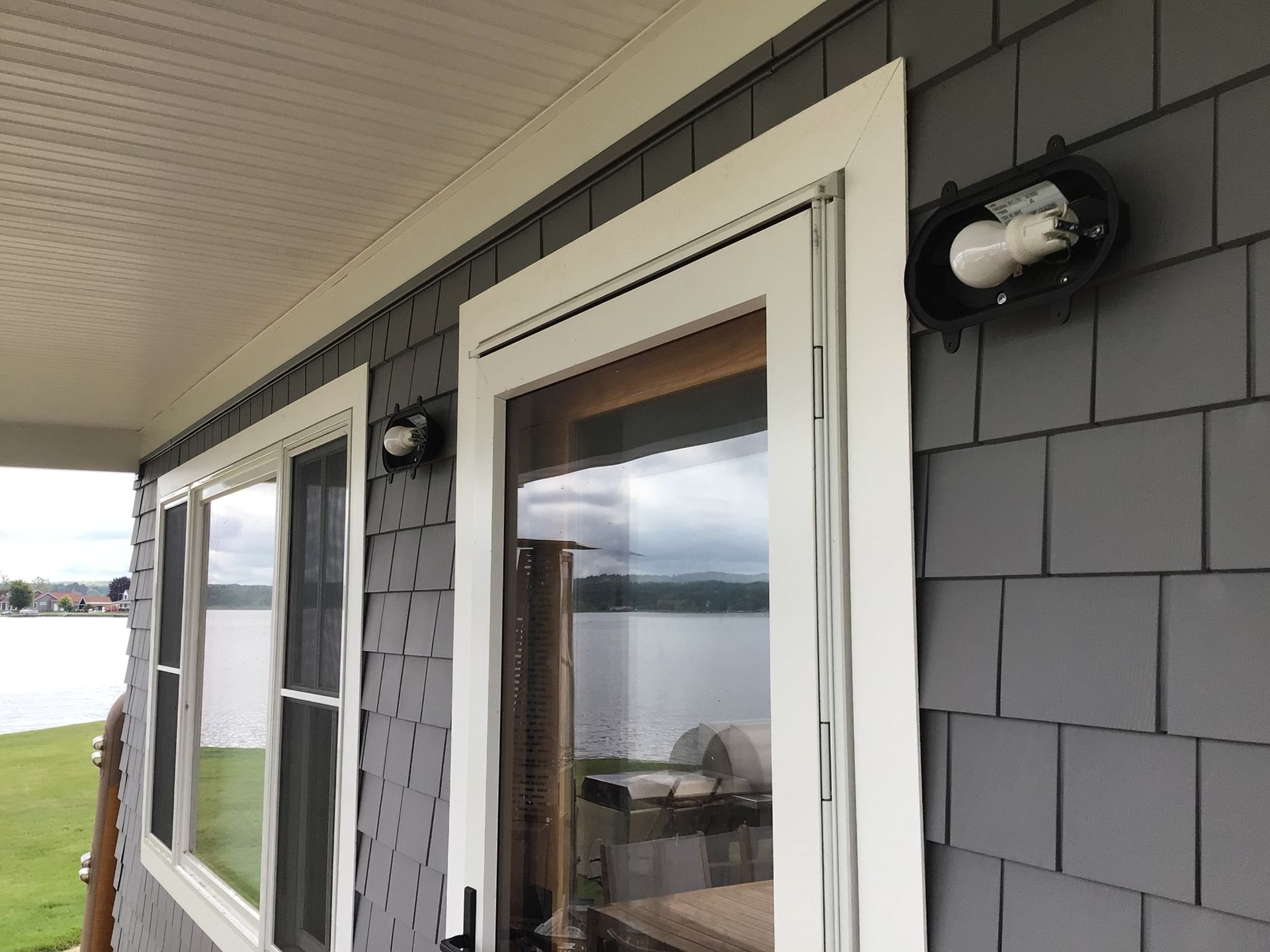 A house with a lot of windows and a light on the side
