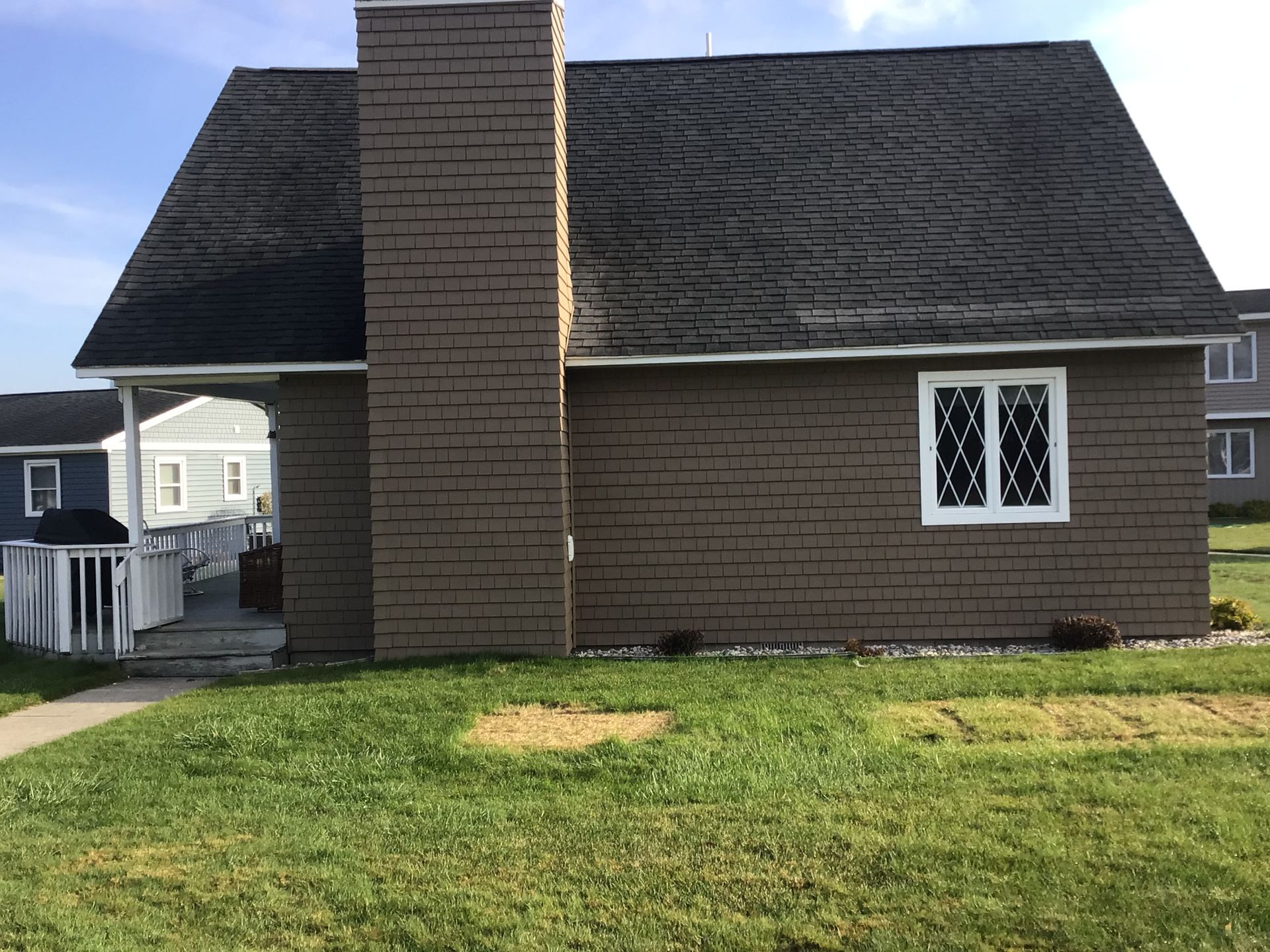 A brick house with a chimney on the side of it