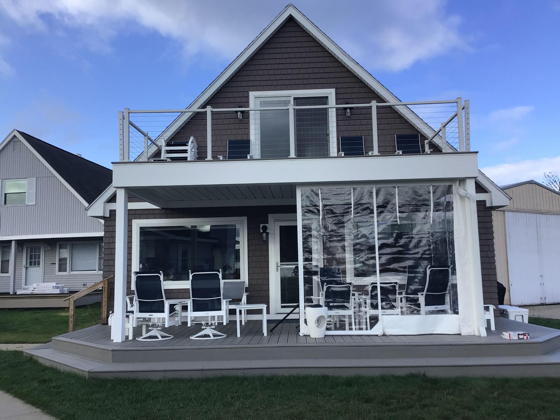 A house with a balcony and chairs on it