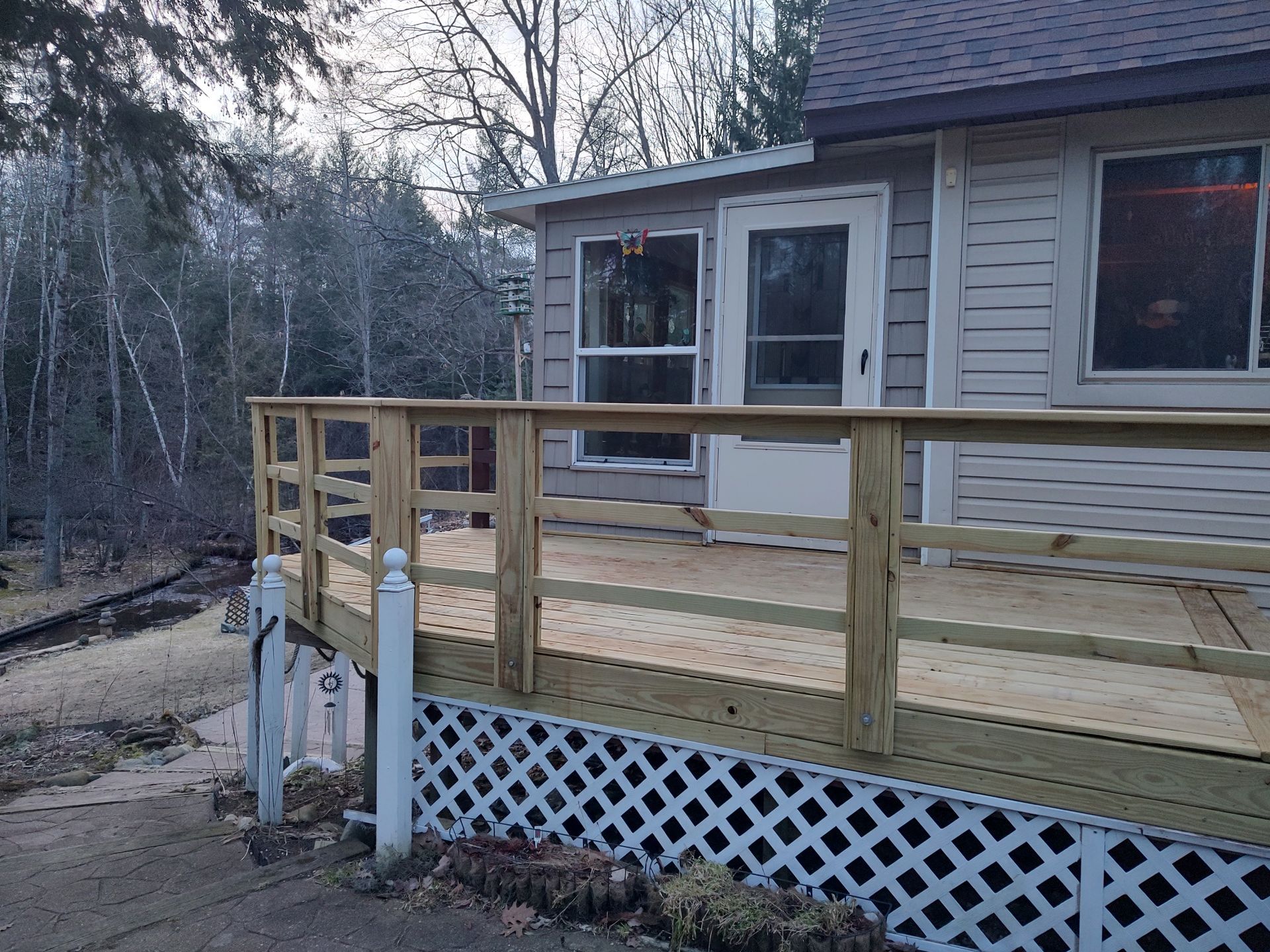 A house with a wooden deck in front of it