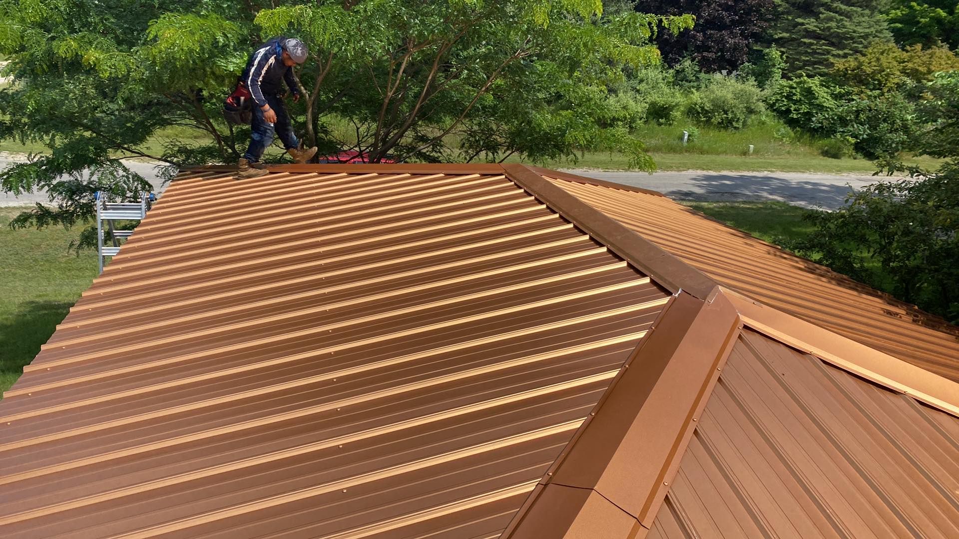 A man is working on the roof of a house.