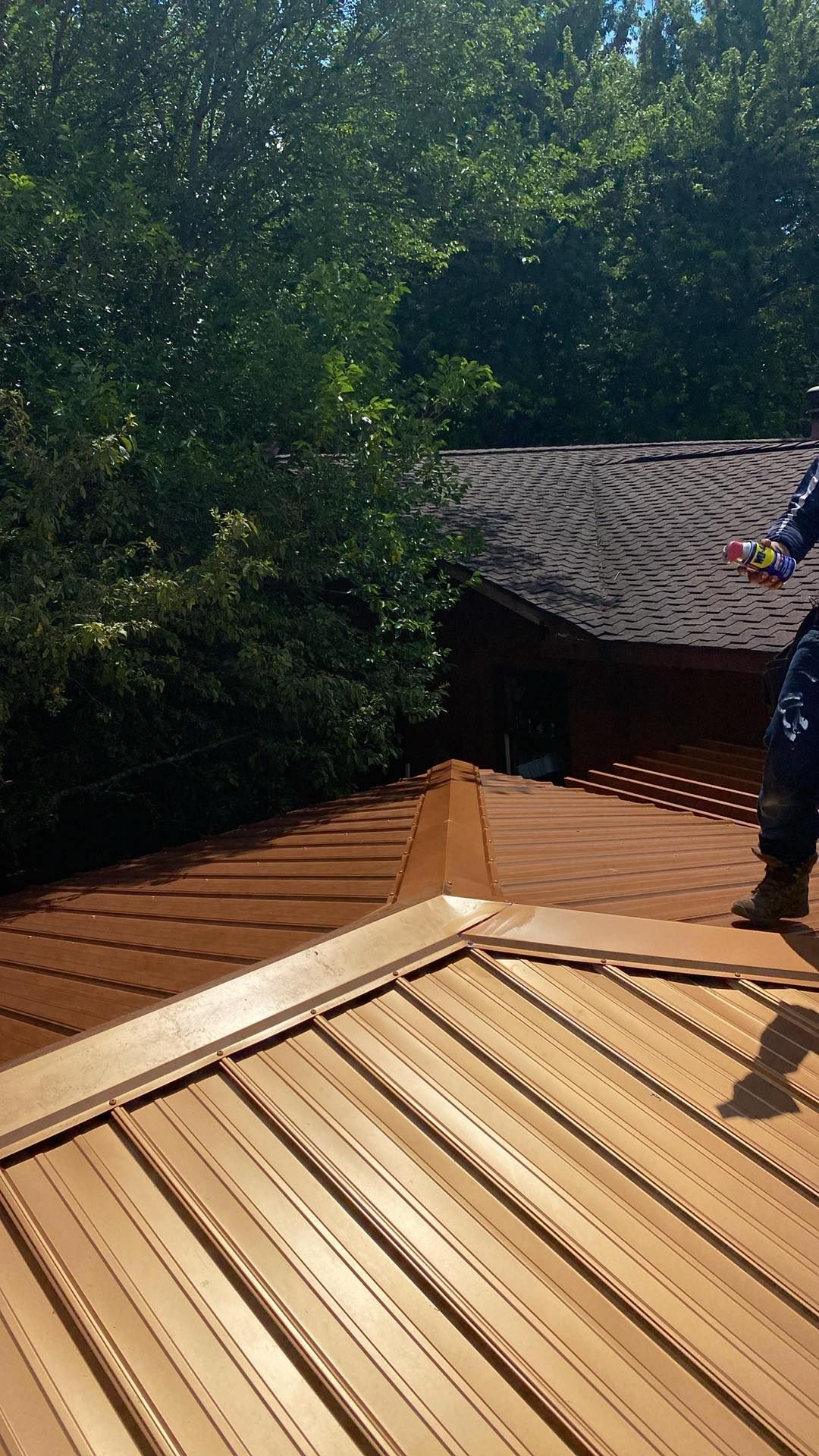 A man is standing on top of a wooden deck.