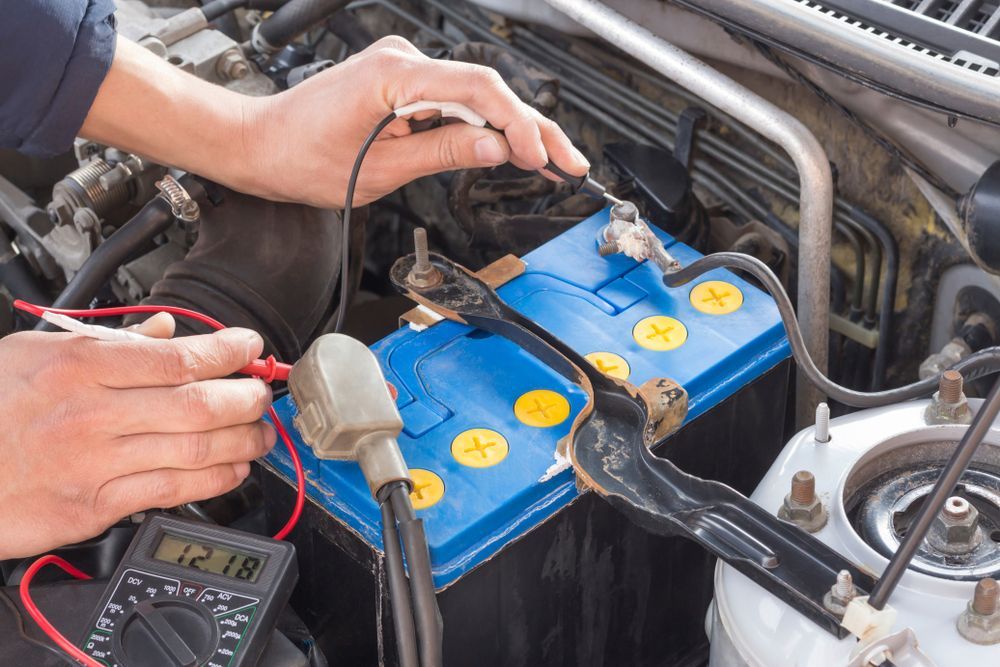 A Person Uses A Multimeter To Test The Voltage Of A Battery — Auto Inspections & Road Services N.T in Woolner, NT