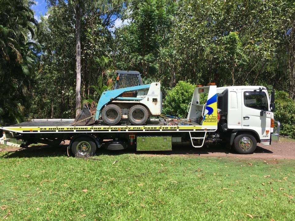 A White Flatbed Truck Parked On A Grassy Area — Auto Inspections & Road Services N.T in Woolner, NT