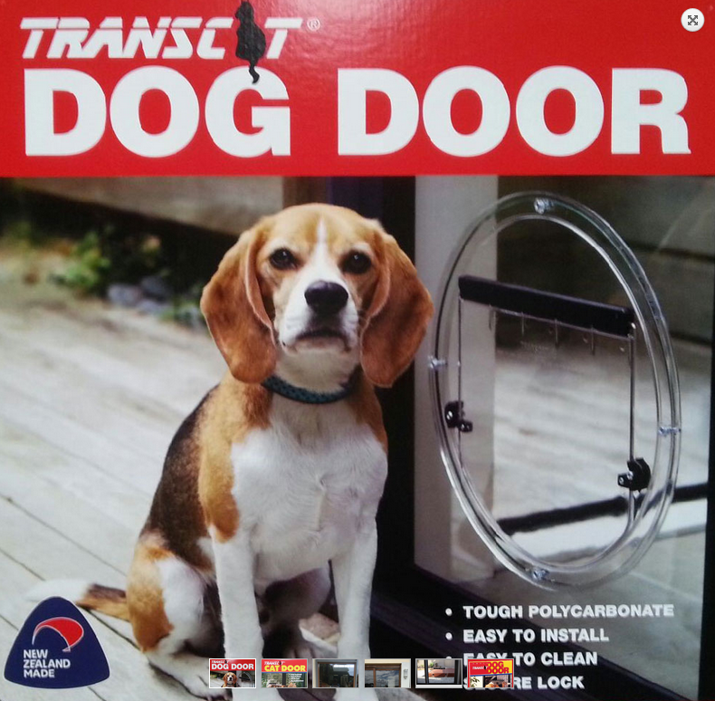 Beagle beside a transparent dog door with packaging text “TRANSIT DOG DOOR” on red background