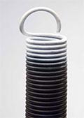 A close up of a garage door spring on a white background.