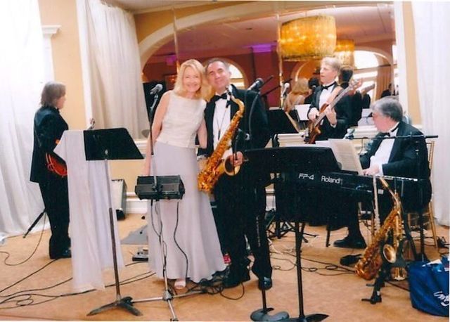 Ginny Bales and band performing at a formal event in CT