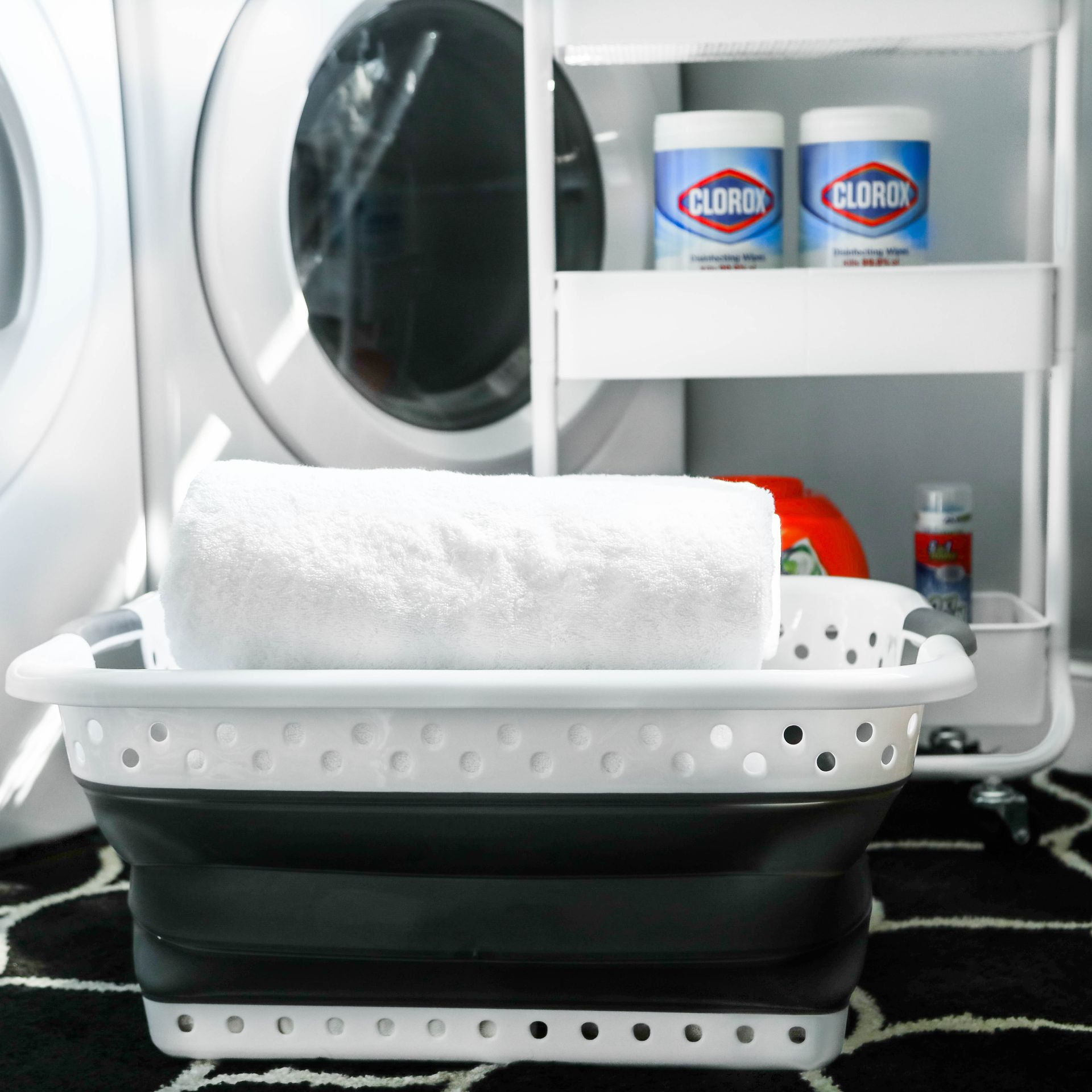 A laundry room with clorox bottles on a shelf