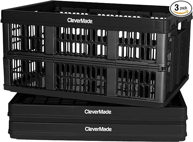 Two black plastic crates are stacked on top of each other.