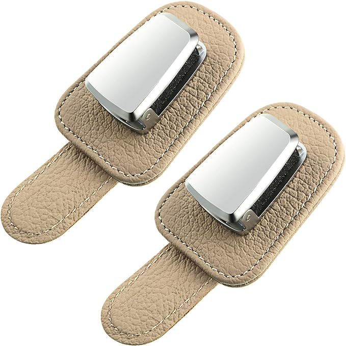 A pair of tan leather cufflinks with a silver buckle