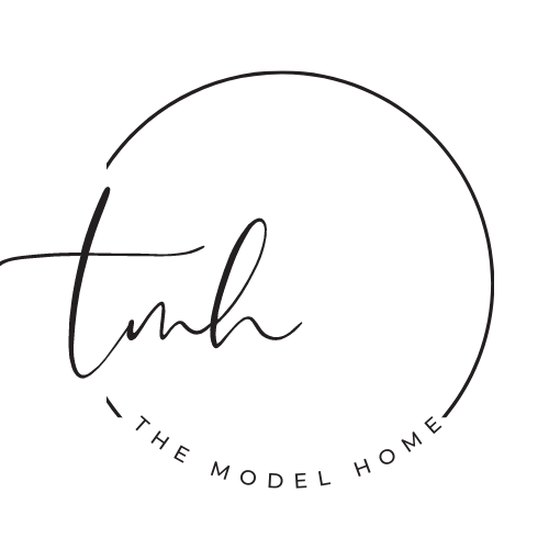 A black and white logo for the model home.