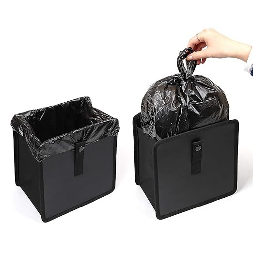A person is putting a trash bag into a trash can.
