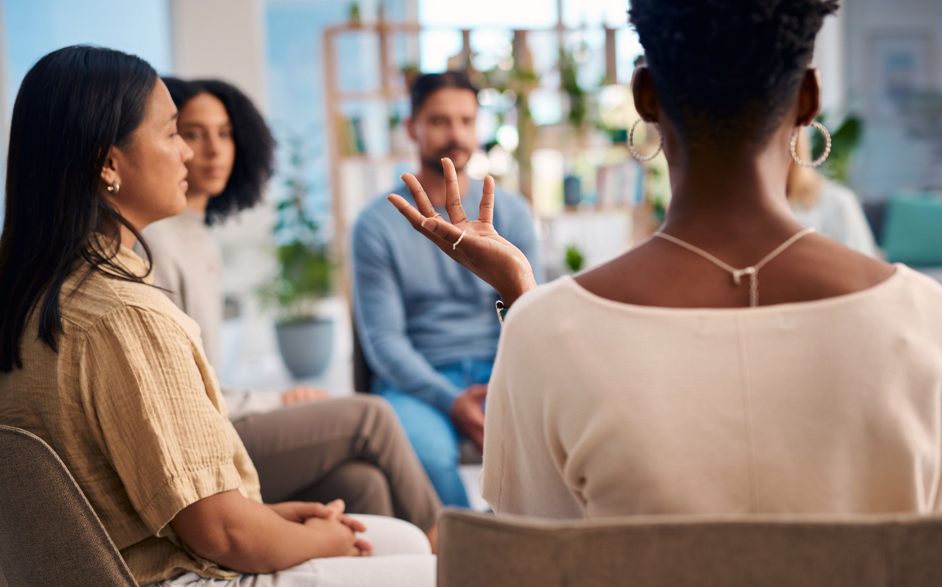 A group of people are sitting in a circle having a conversation.