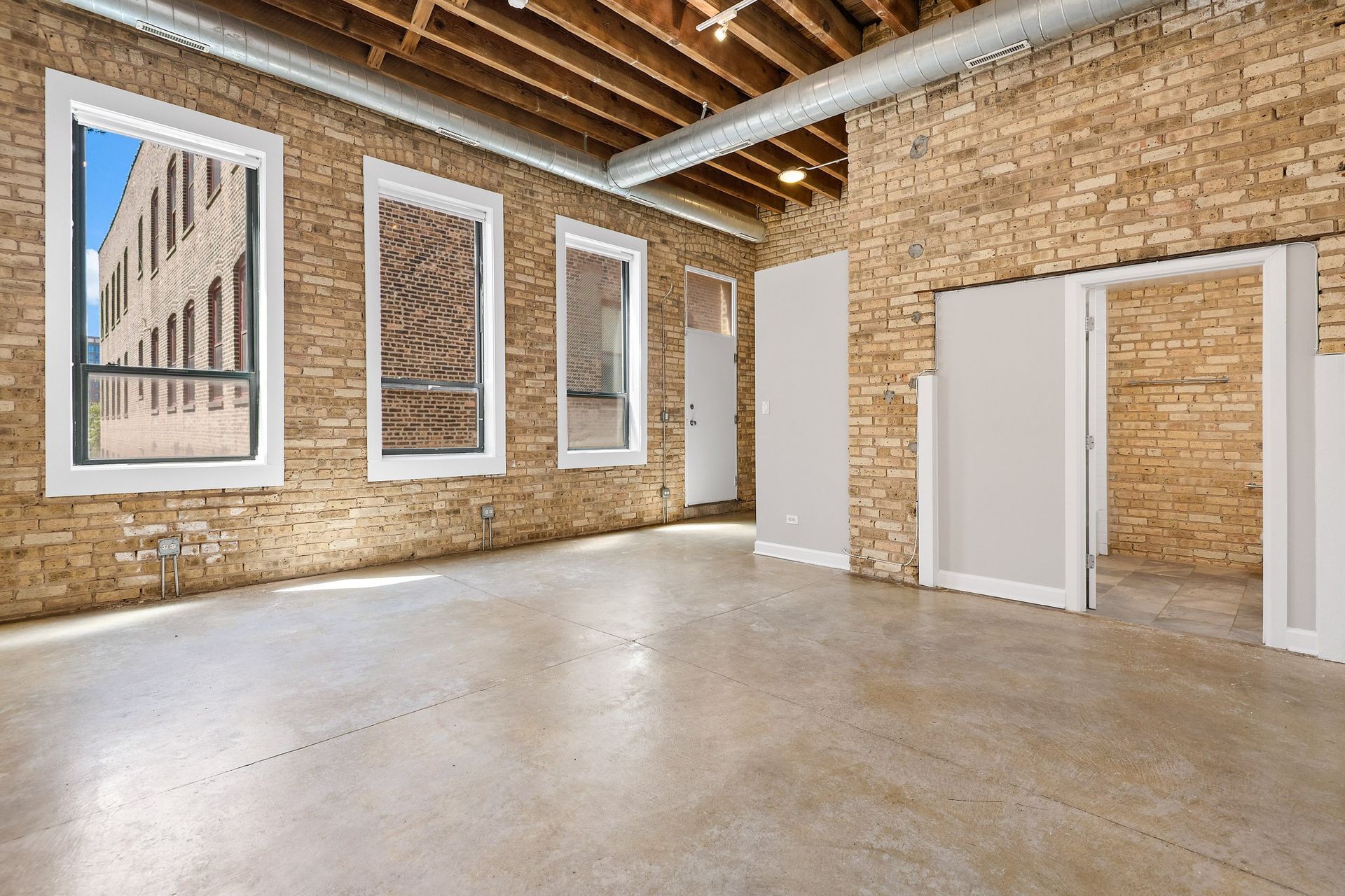 the interior of a building with brick walls and a concrete floor