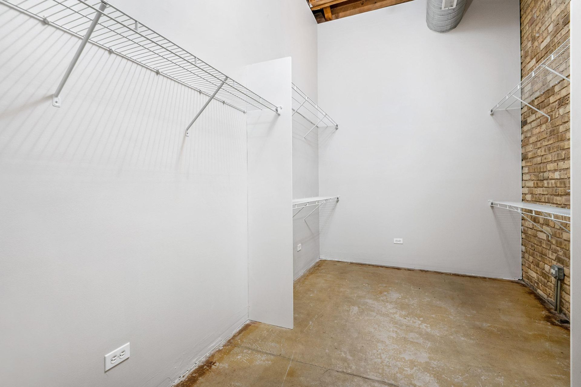 an empty room with white walls and a walk in closet