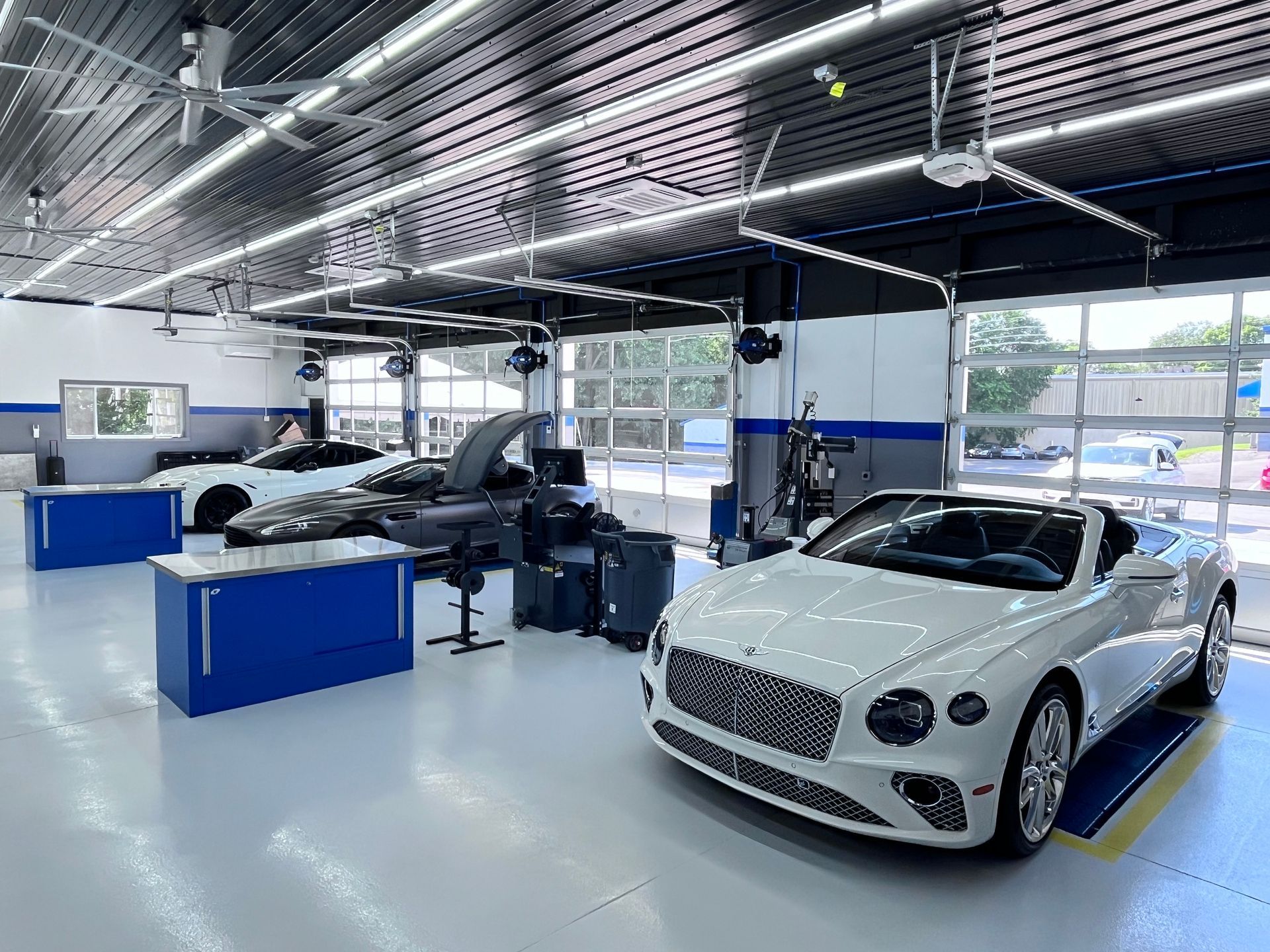 Bright auto shop with cars | Plum Springs Garage