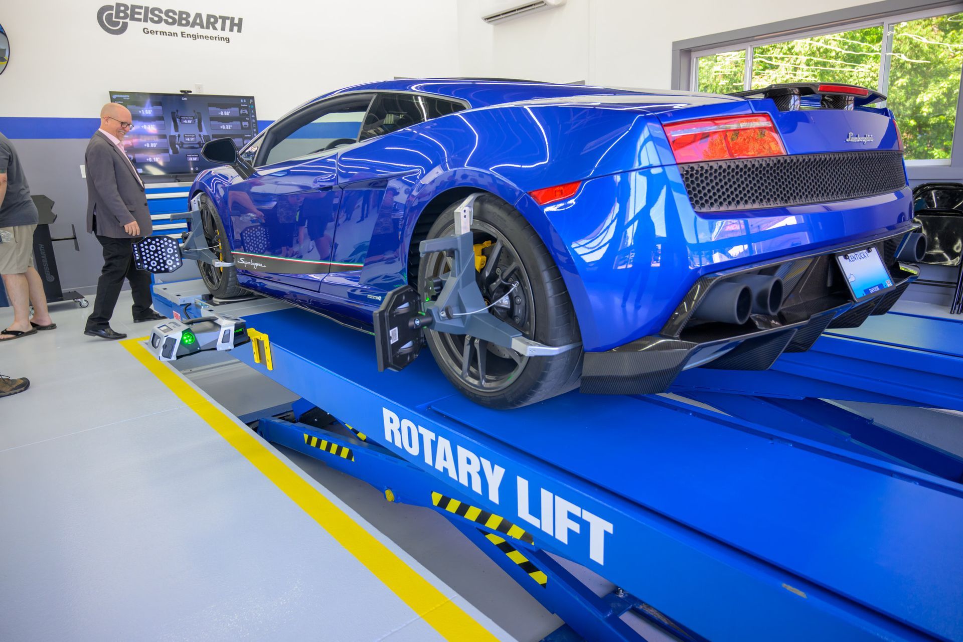 Blue Lamborghini on a blue Rotary lift being inspected | Plum Springs Garage