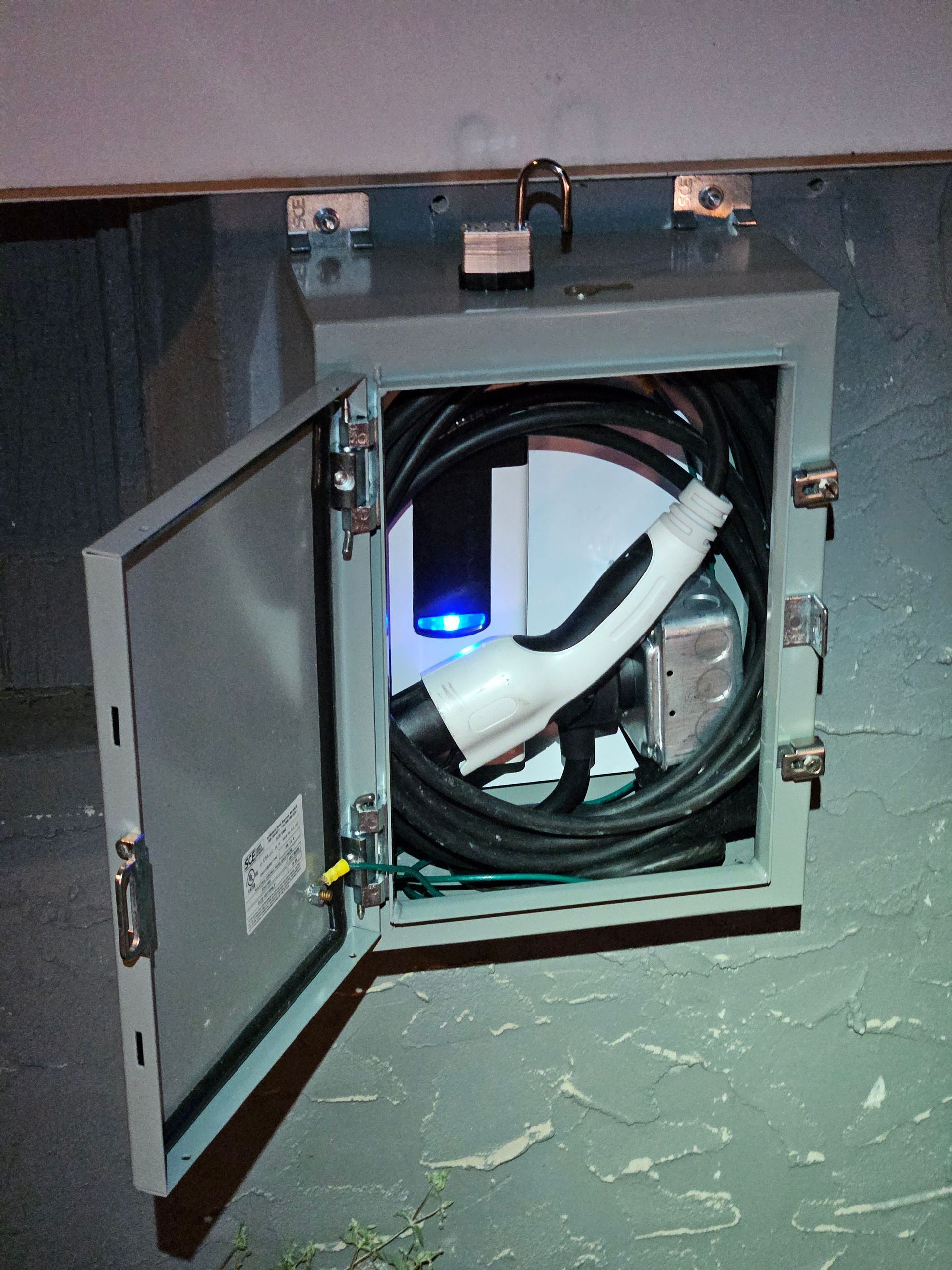 A box with a charger inside of it with the door open