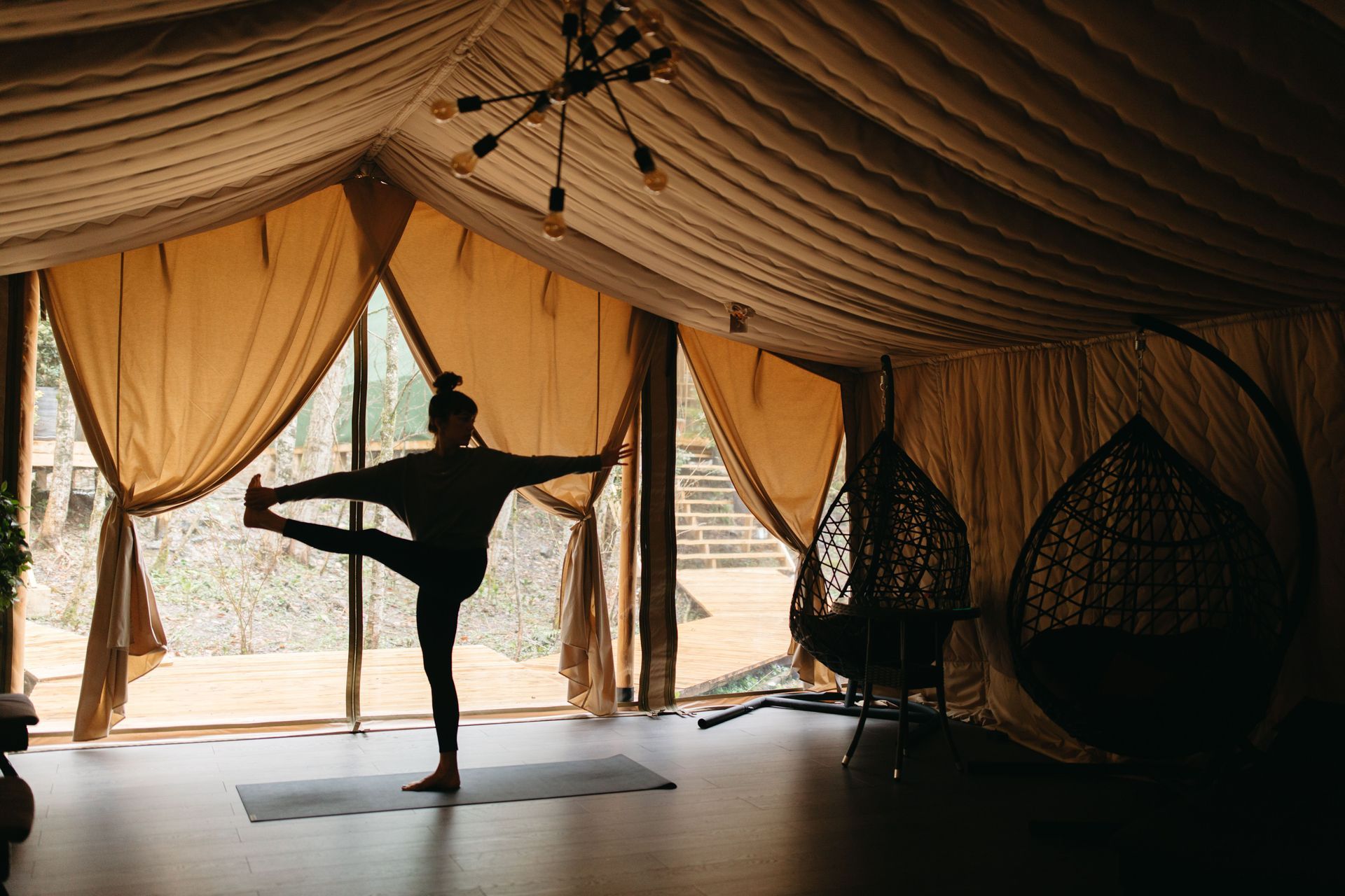 Photorealistic yoga retreat welcome briefing in a bright studio, small group seated with notebooks while the host explains the schedule