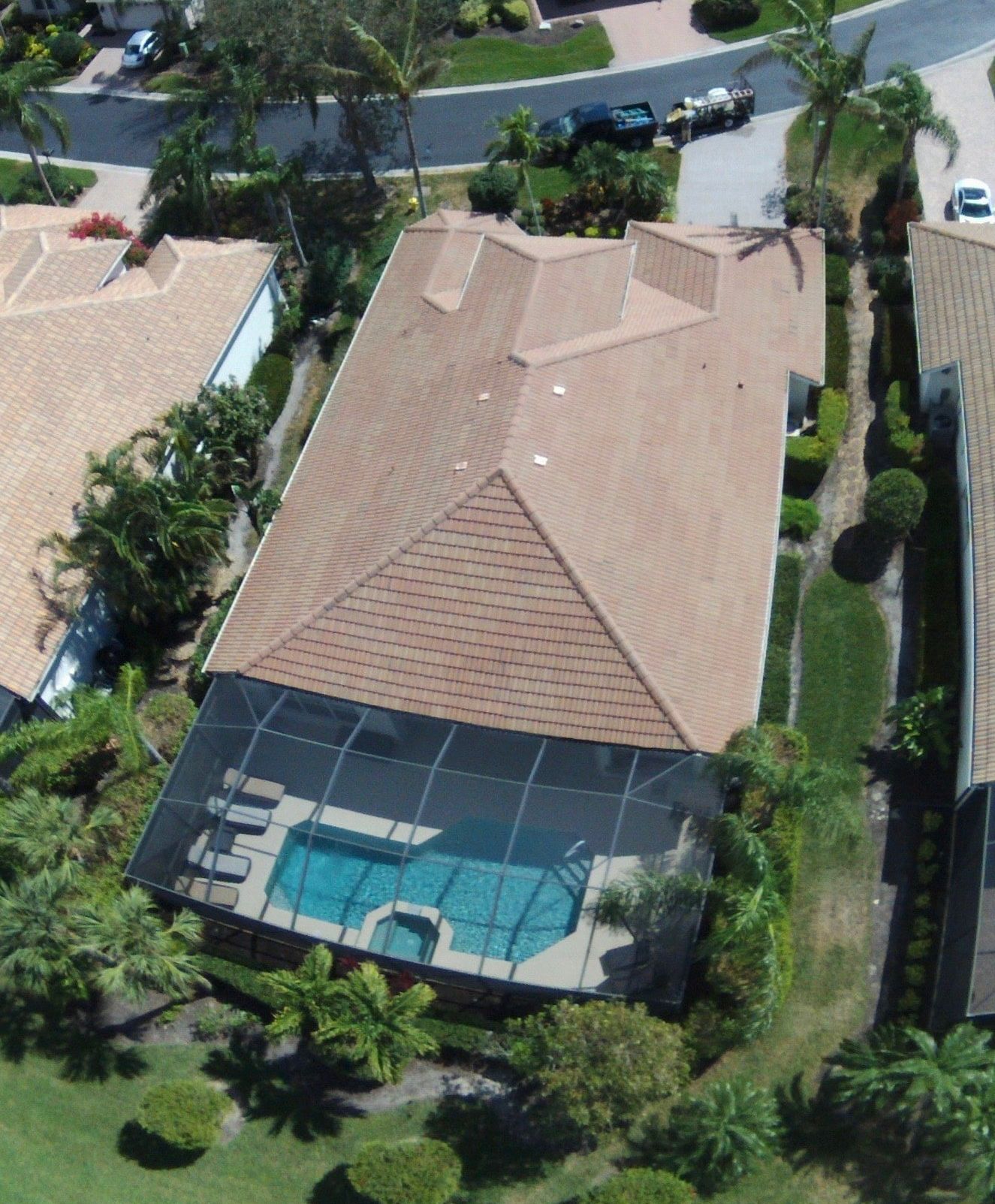 An aerial view of a house with a screened in pool
