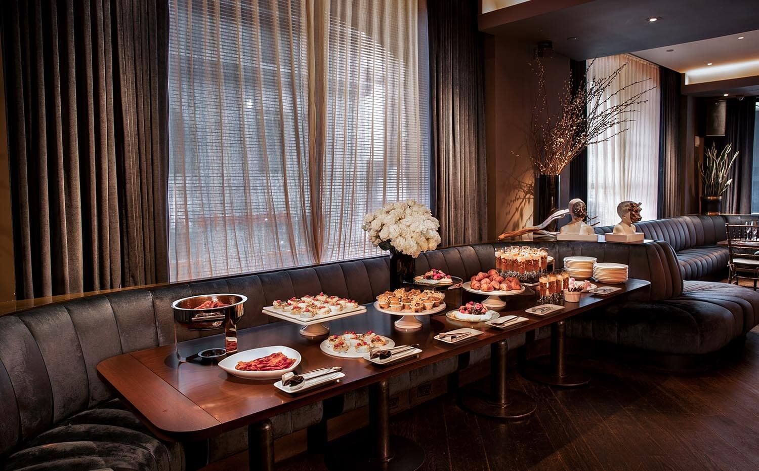 a long table with food and drinks in a meeting room