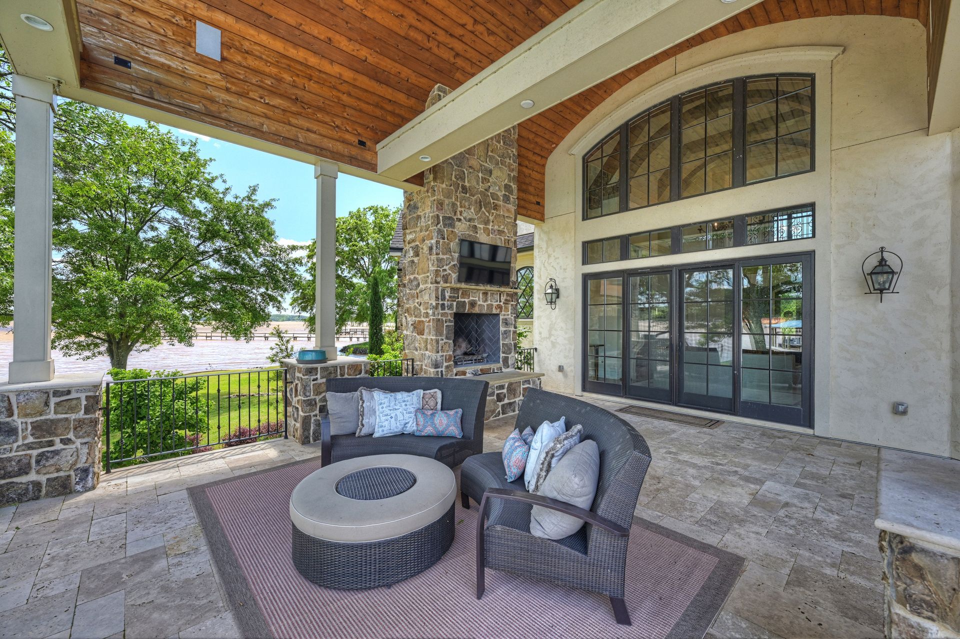 a patio area with a fireplace and chairs | Charlotte, NC | Harland Building Group 