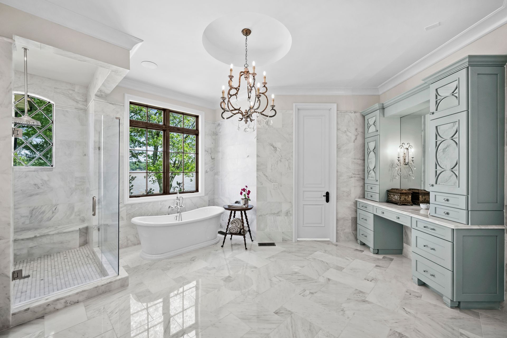 a bathroom with a tub and a chandelier hanging from the ceiling | Charlotte, NC | Harland Building Group 