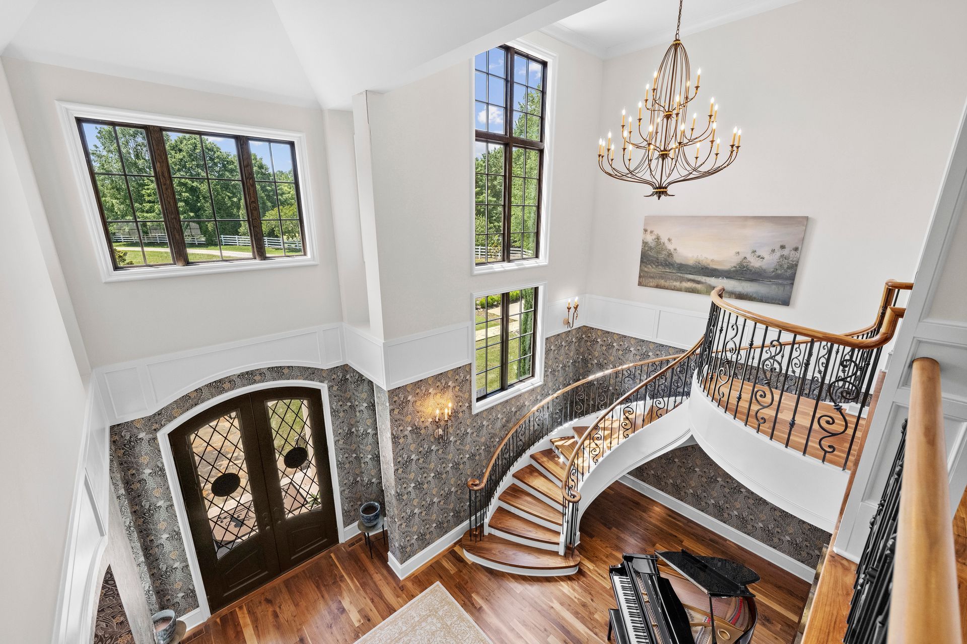 a spiral staircase with a piano in front of it | Charlotte, NC | Harland Building Group 