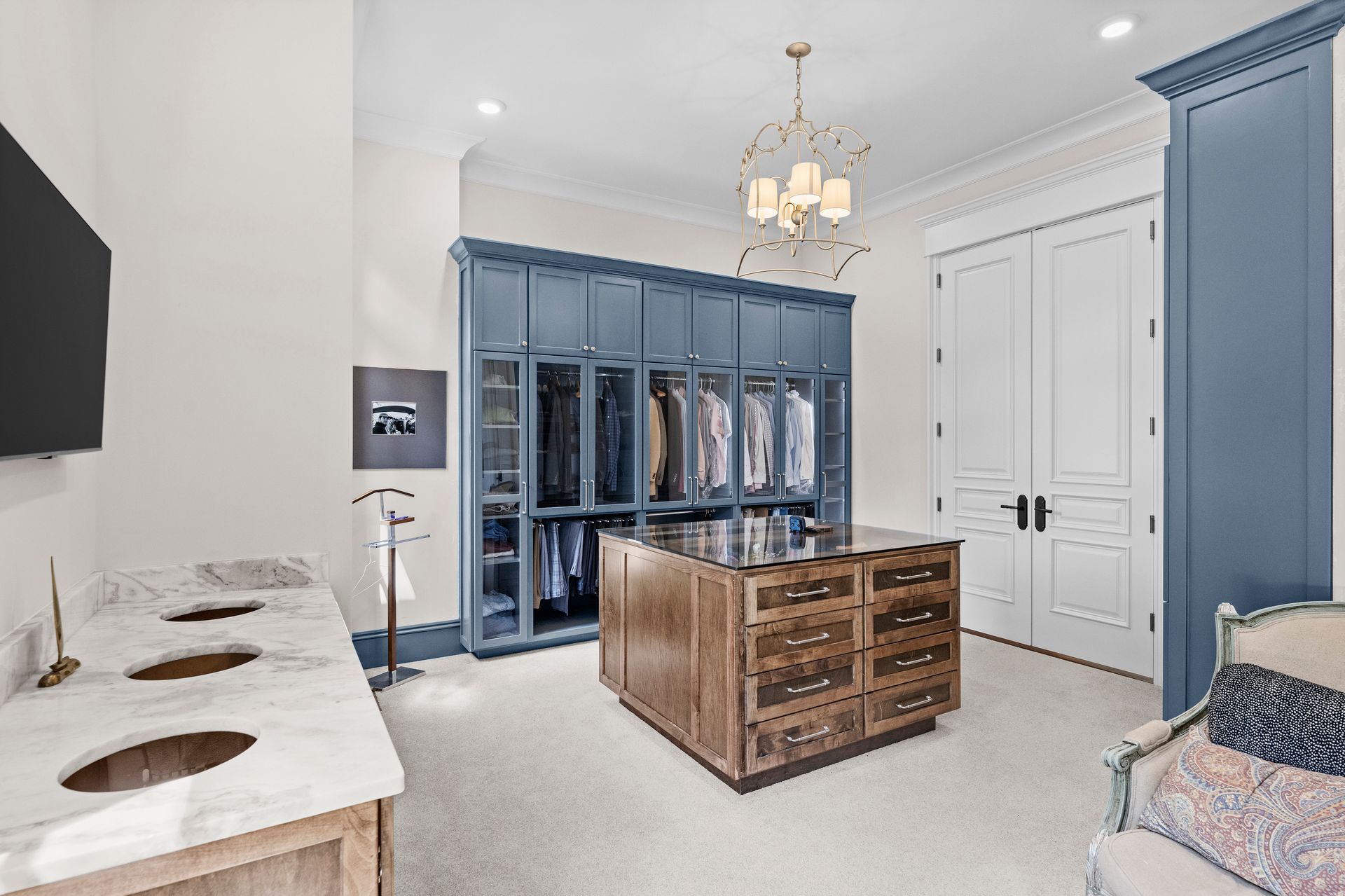 a walk in closet with a large island in the middle | Charlotte, NC | Harland Building Group 