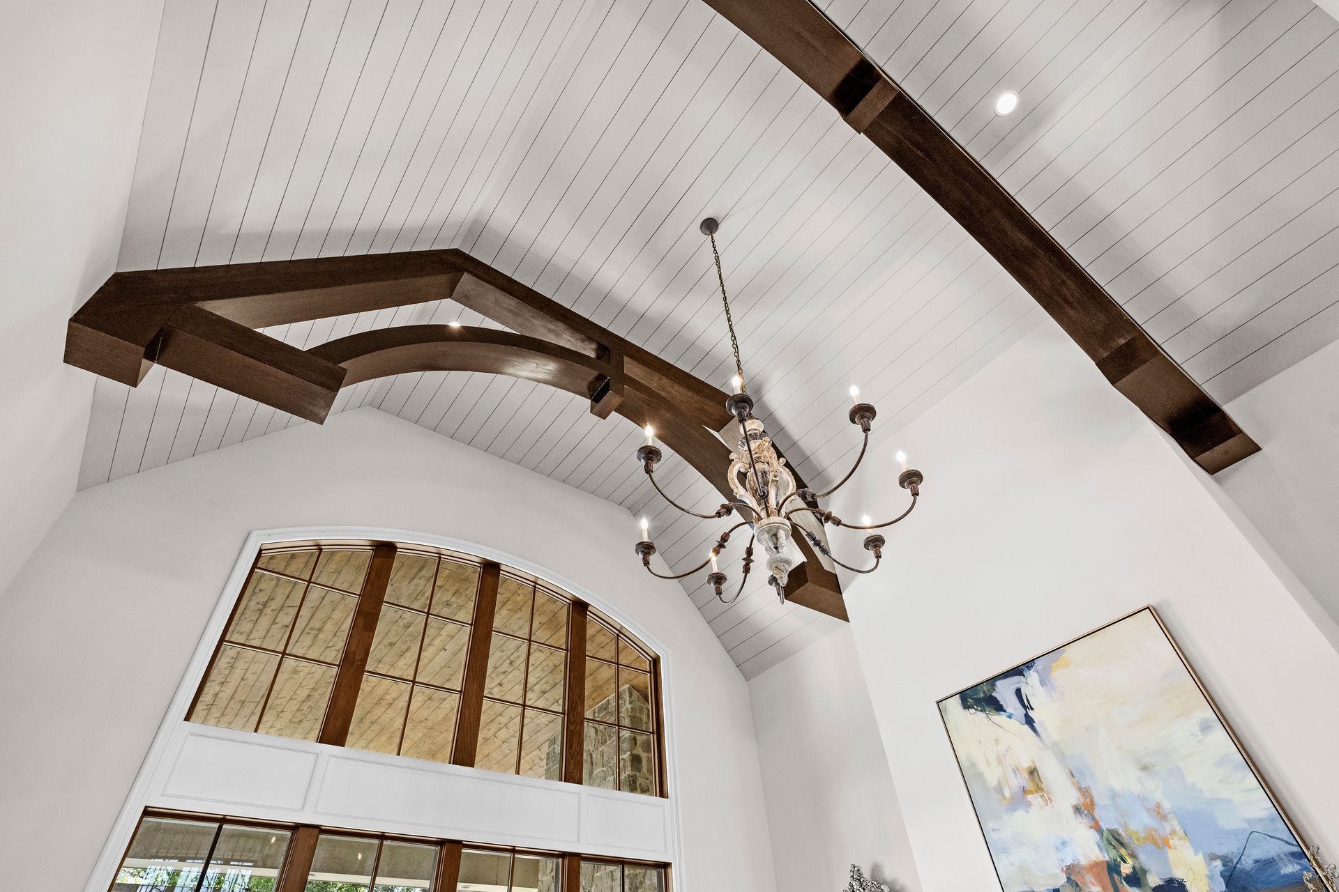 a chandelier hangs from the ceiling above a large window | Charlotte, NC | Harland Building Group 